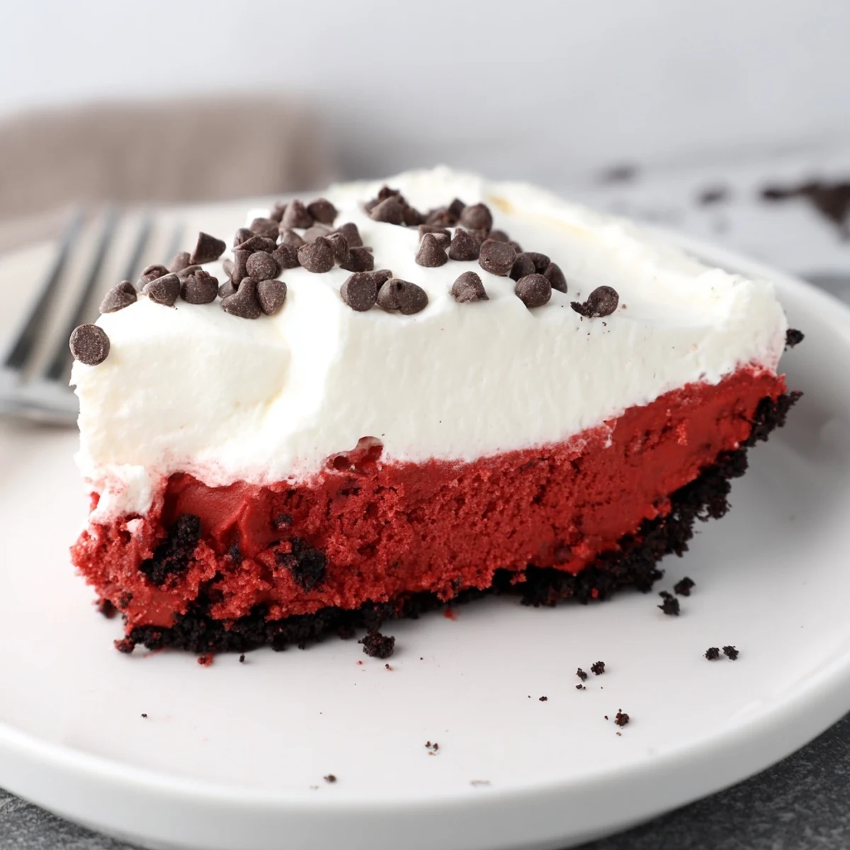 Decadent Red Velvet Cookie Dough Pie with chocolate crust and creamy whipped topping.  
