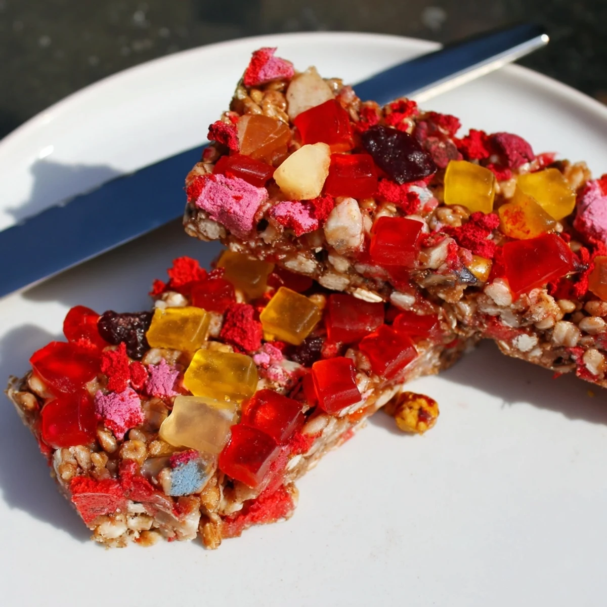 Colorful homemade gummies and freeze-dried candies atop chewy DIY snack bars.  