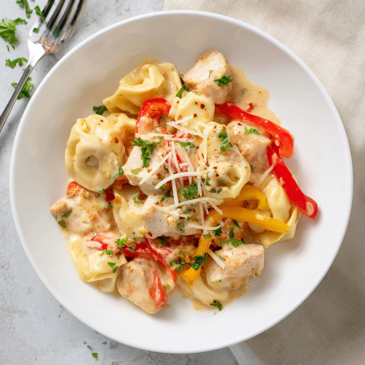 Delicious Zesty Cajun Garlic Parmesan Chicken Tortellini with tender chicken and colorful vegetables.