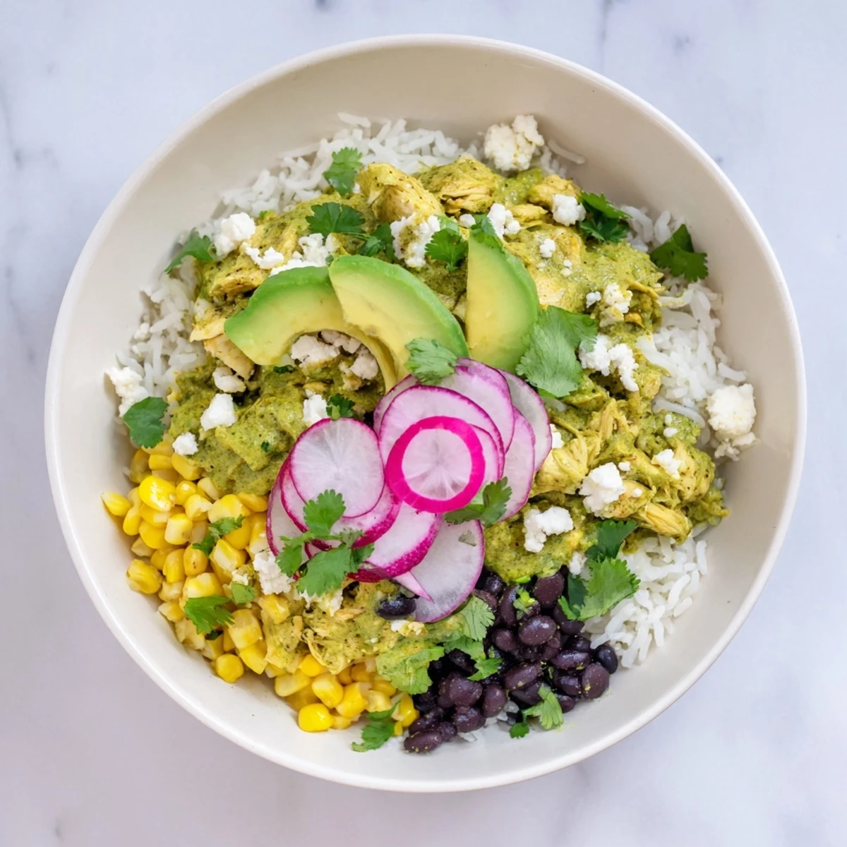 This delicious Green Enchiladas Rice Bowl features tender chicken and a creamy, flavorful texture.