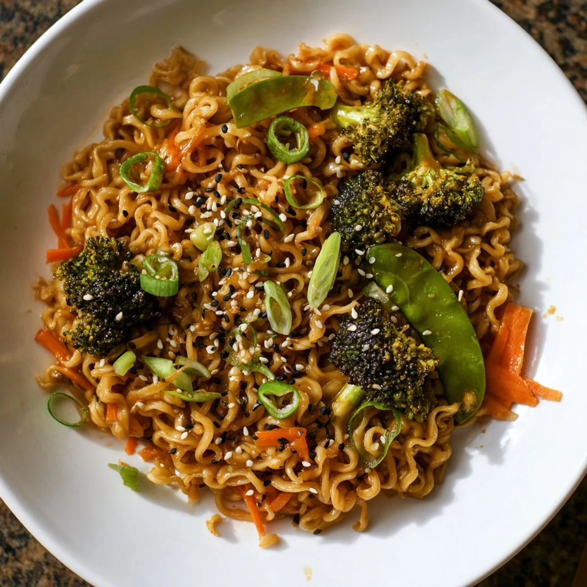 Savory ramen noodle stir-fry remix, showcasing perfectly coated noodles alongside crisp vegetables and sprinkled sesame seeds.