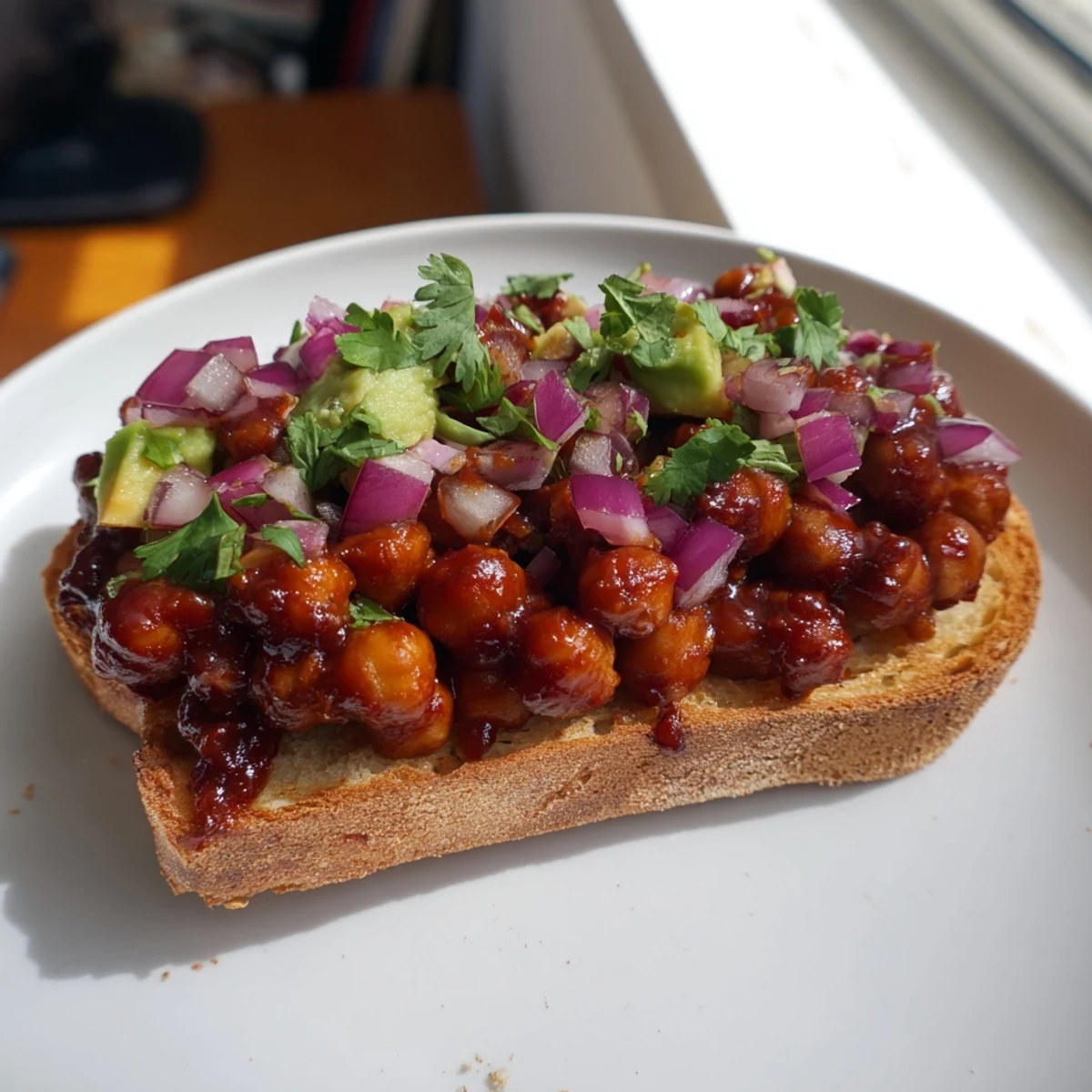 Golden BBQ chickpeas on toast, with smoky aroma, plated and ready for a delicious vegan lunch.