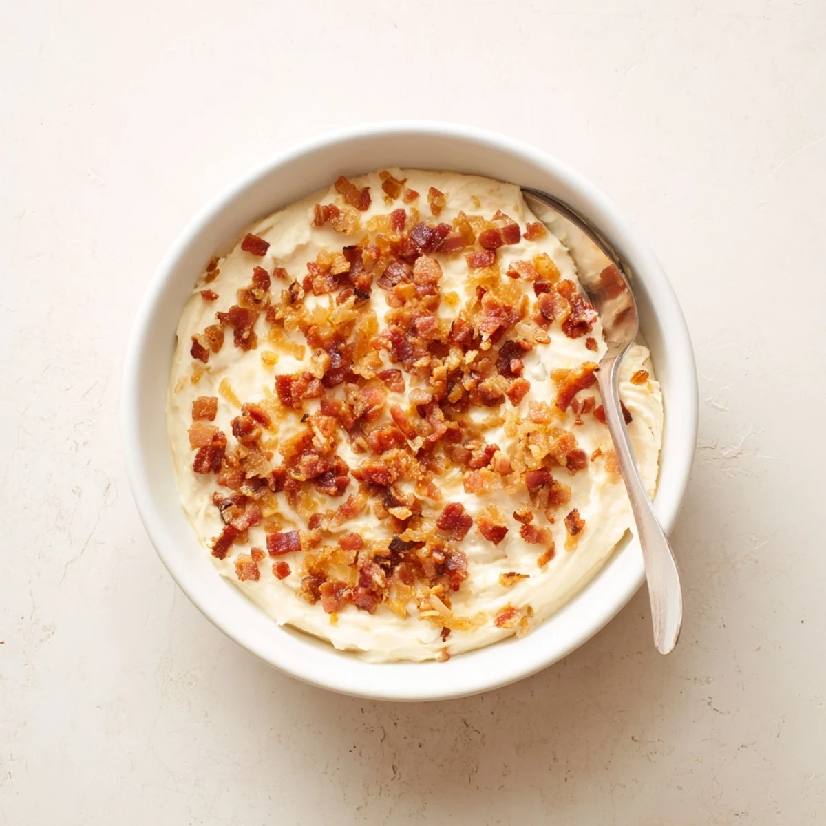 This creamy Caramelized Onion and Bacon Dip is studded with crispy bacon bits, ready to scoop with chips.