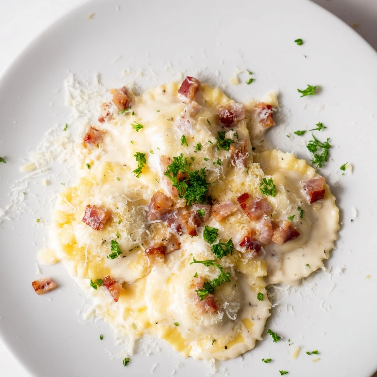 A close-up of Olive Garden Ravioli Carbonara showcases the creamy sauce, cheese, and fresh parsley garnish.