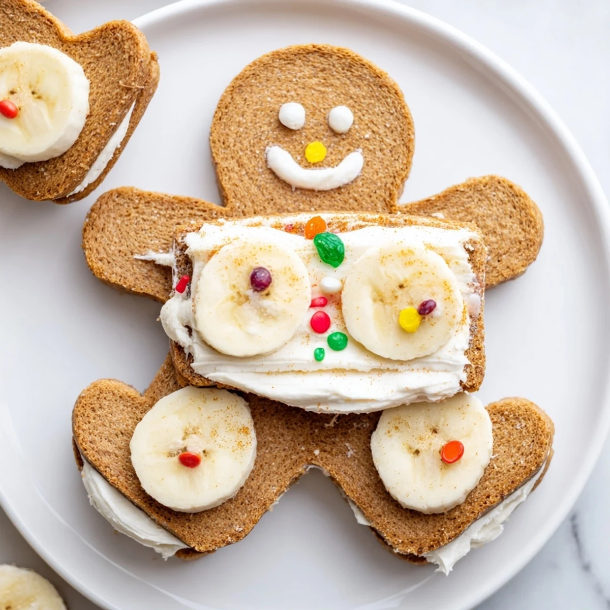 Festive gingerbread man sandwich cutouts ready: soft bread, sweet frosting, and playful raisin details.