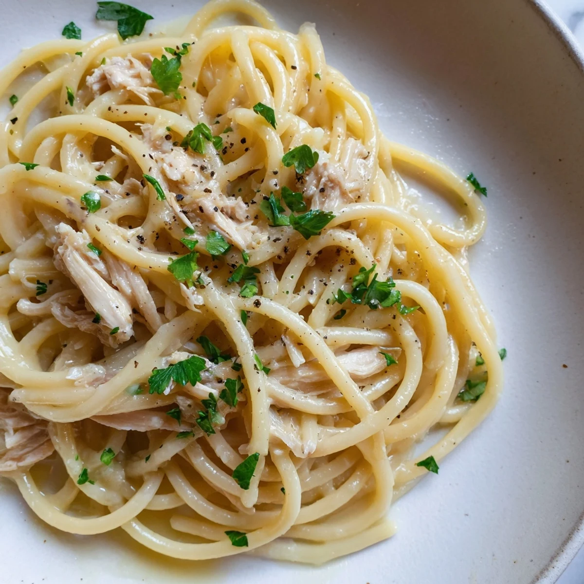 Fragrant Simple Garlic Butter Bucatini, tossed with garlic and chicken, ready to serve as a comforting meal.