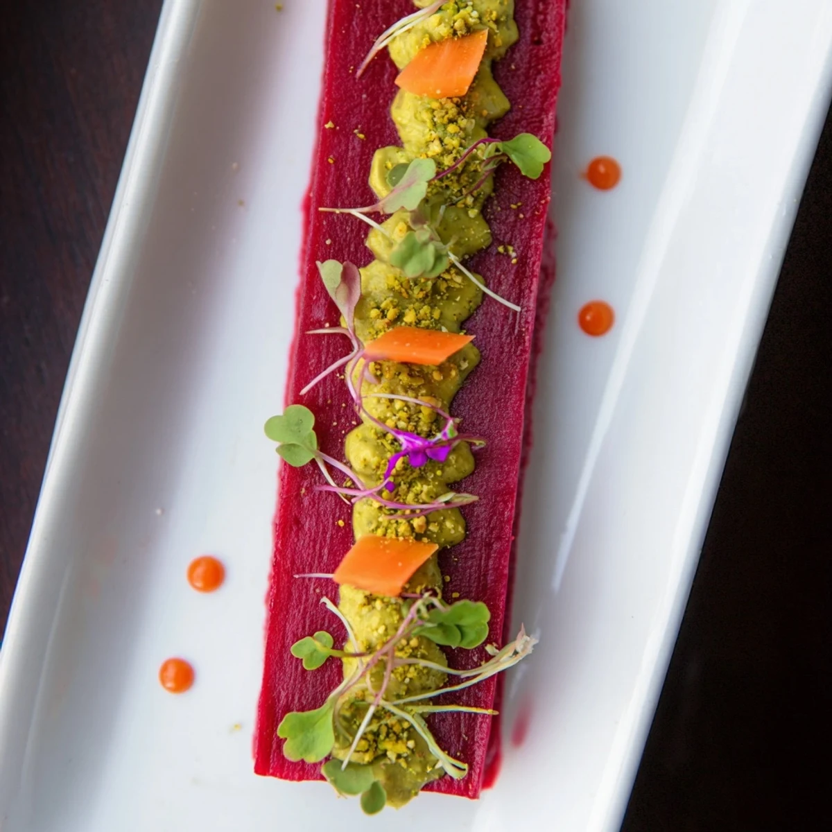 A close-up view of The Modernist Stripe recipe, showing colorful purees artfully arranged to eat.