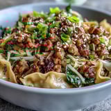 Steaming Potsticker Noodle Bowls with tender rice noodles, sautéed vegetables, and chopsticks ready to eat.