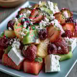 A colorful spread of fresh fruits paired with fluffy coconut whipped cream for a vibrant, healthy dessert.