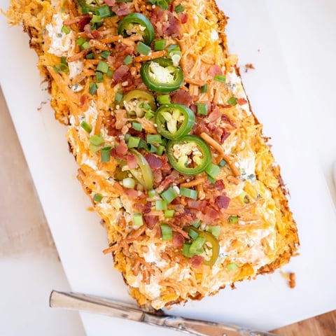 Loaded Jalapeño Pretzel Sheet Cake topped with crispy bacon and creamy cheese deliciously tempts the taste buds.  