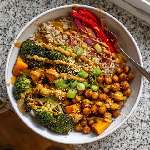 Vibrant Bold Sauce Drizzle Bowls topped with delicious roasted vegetables and zesty sauces.  