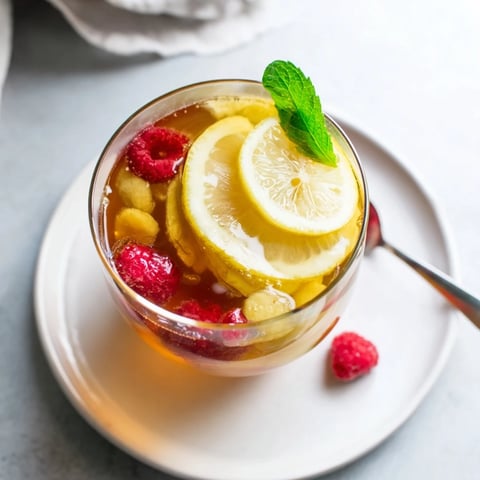 Crisp and vibrant Kombucha-Style home-brew mocktails garnished with fresh berries and mint leaves.  