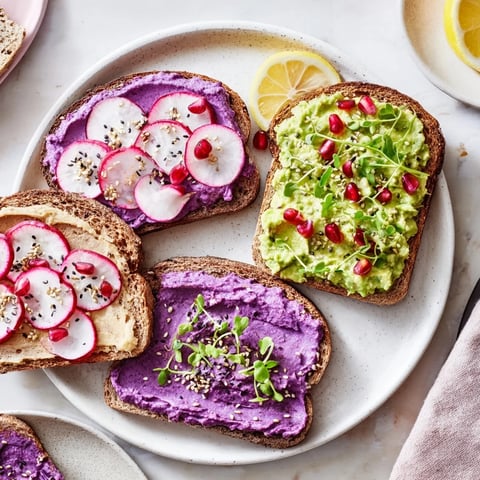 Vibrant Bright & Bold Breakfast Toasts topped with ube, avocado, and fresh herbs.  