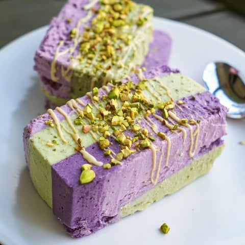 Creamy ube & pistachio ice cream bars with vibrant colors, perfect for summer.  
