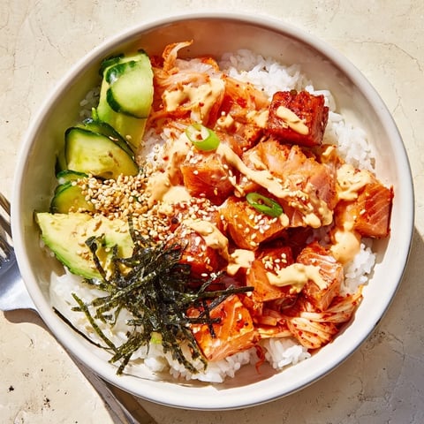 Crispy Salmon Rice Bowl with flavorful toppings and creamy spicy mayo drizzled on top.  