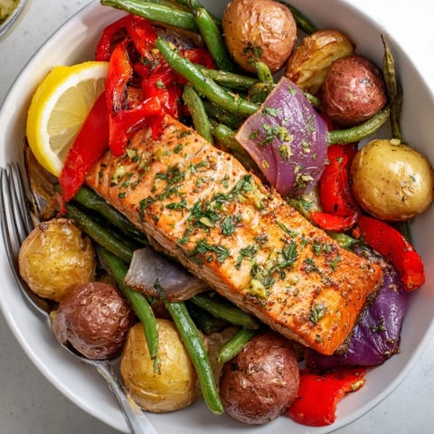 Vibrant Lemon Herb Salmon & Potato Sheet Pan with roasted veggies and fresh herbs.  