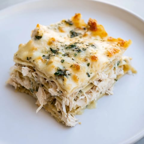 Golden brown bubbling Rosemary Chicken Lasagna fresh from the oven, served hot.