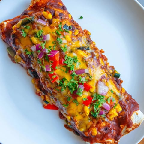 Farmers Market Vegetarian Enchiladas: A close-up of cheesy, bubbling, and flavorful baked enchiladas.