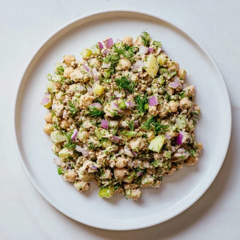 Creamy vegan chickpea tuna salad served on a whole-wheat sandwich, perfect for a satisfying lunch.