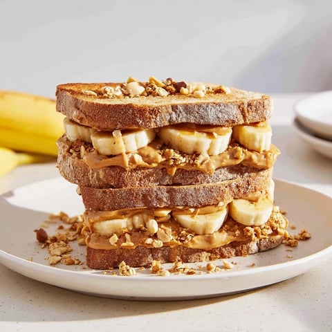 Golden toasted bread layered with peanut butter and sweet bananas in this upgraded peanut butter banana sandwich.