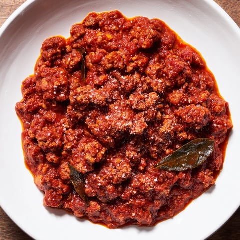 Classic Tuscan Ragu simmering slowly, a hearty meat sauce, perfect atop steaming pasta.