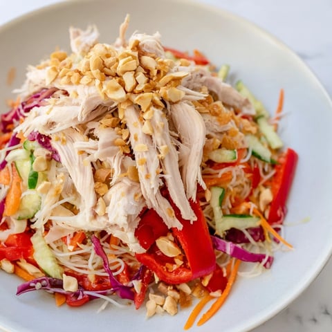 A colorful bowl of Vietnamese Crunch Noodle Salad with shredded chicken, ready to be enjoyed.