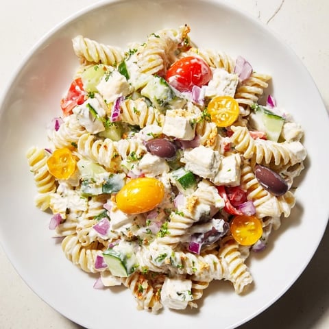 Greek Yogurt Million Dollar Christmas Pasta Salad, a colorful medley of pasta, cheese, and vegetables.