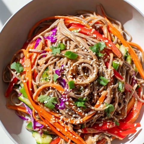 Cool soba noodle salad, tossed with colorful vegetables, drizzled in a creamy sesame-peanut dressing.