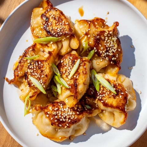 Crispy air fryer frozen dumplings glazed with shimmering sesame oil, ready to serve!