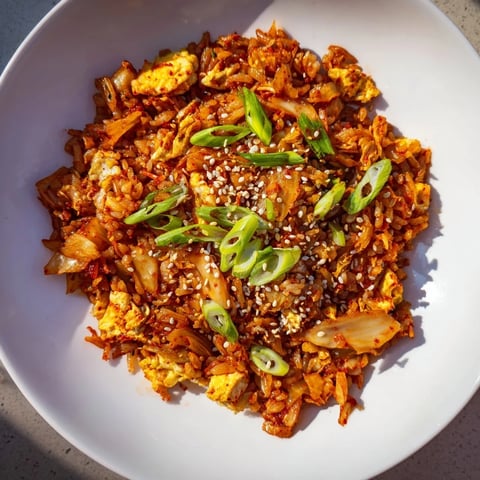 Steaming bowl of Spicy Kimchi Fried Rice, showcasing vibrant colors and a delightful aroma.