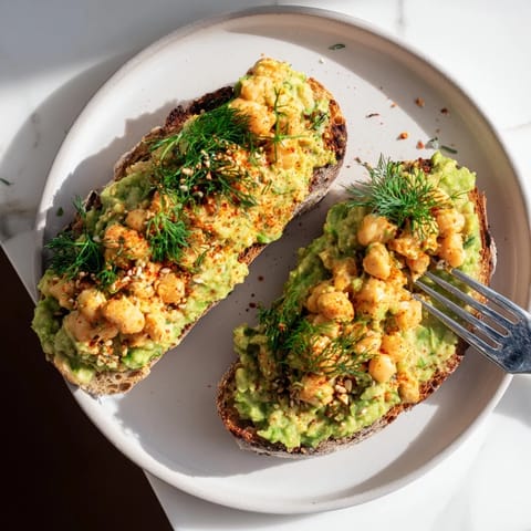 Close-up of a flavorful avocado toast; the chickpea topping adds a delightful, savory texture.