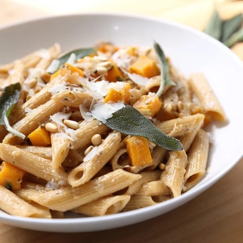 A close-up of creamy butternut squash & sage brown butter pasta; a beautiful Italian-inspired vegetarian dish.