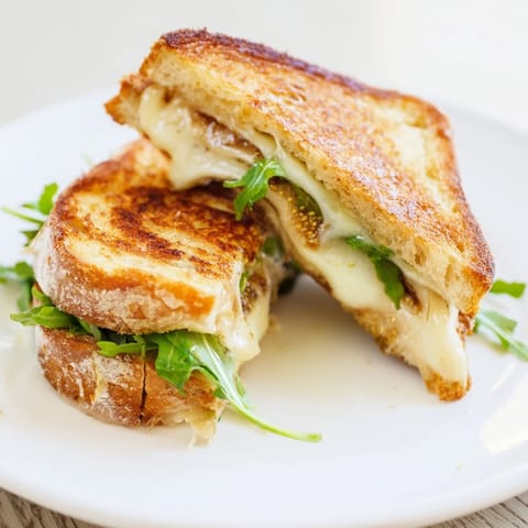 Crispy sourdough encasing melted Brie and sweet fig preserves in a Fancy Grilled Cheese sandwich.