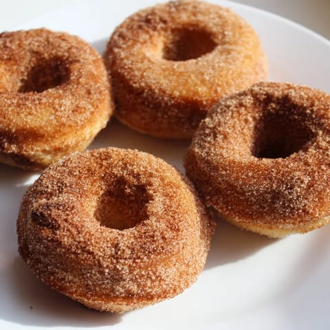 Freshly air-fried 1-Minute Air Fryer Donuts, their tender insides coated with melted butter and cinnamon.
