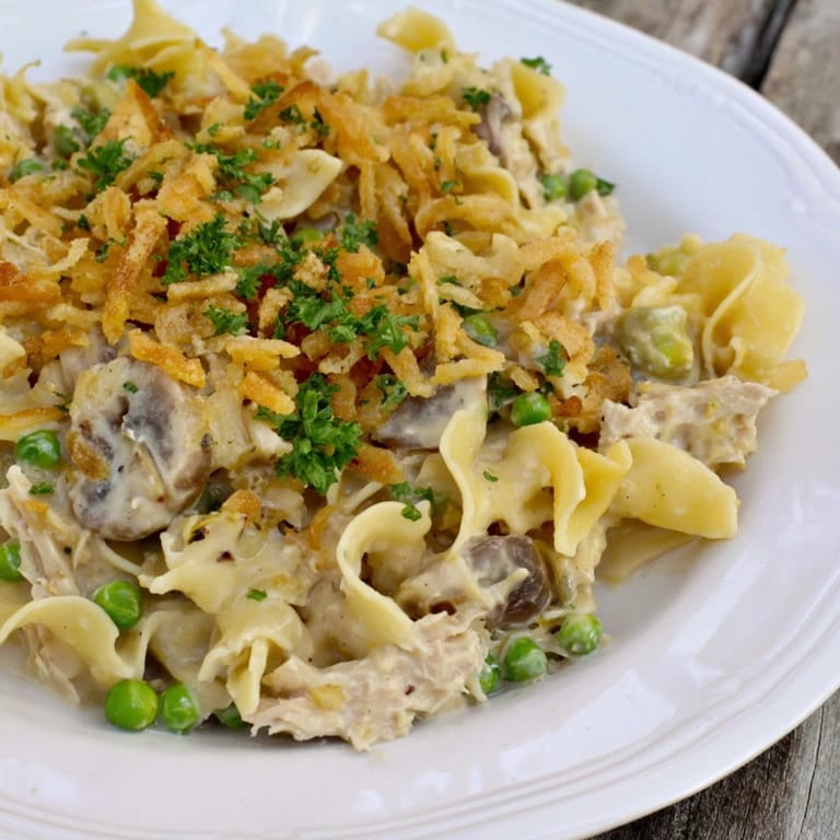 A comforting close-up featuring Tuna Noodle Casserole with a crispy, delicious topping.