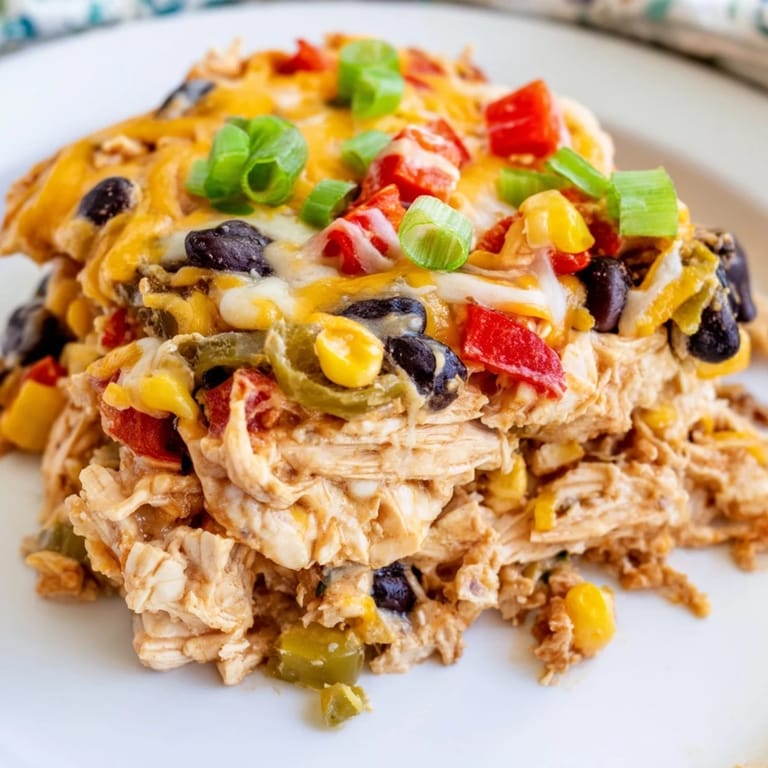Sizzling close-up: a cheesy Taco Bell Copycat Chicken Bake, showing the tender chicken and savory spices.