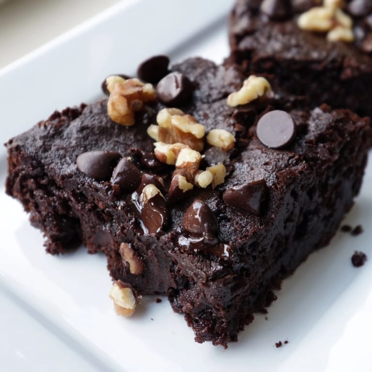 A slice of rich black bean brownie, showing off a perfectly moist texture and lovely aroma.